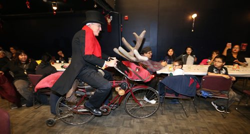 JASON HALSTEAD / WINNIPEG FREE PRESS

Event emcee Al Simmons makes his entrance on his Rudolph bike at the West End Cultural Centre's annual holiday dinner and concert on Dec. 6, 2017. (See Social Page)
