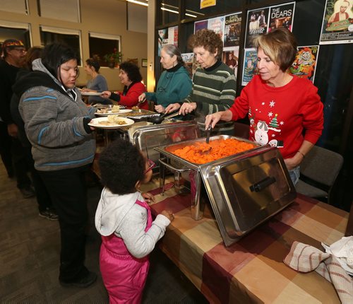JASON HALSTEAD / WINNIPEG FREE PRESS

Volunteer Debbie Curtis serves up carrots at the West End Cultural Centre's annual holiday dinner and concert on Dec. 6, 2017. (See Social Page)