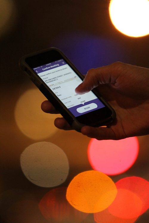 RUTH BONNEVILLE / WINNIPEG FREE PRESS

Winnipeg Free Press reporter Ryan Thorpe books a cab with a online app outside the Pint on Garry street Friday. 
For story on what the local cab service is like.  

See Ryan Thorpe story.   
(ride hailing, ride sharing, uber)
Dec 15, 2017
