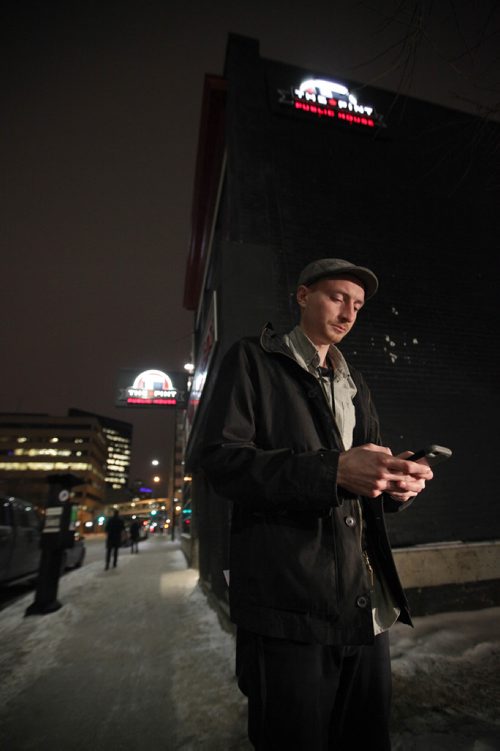 RUTH BONNEVILLE / WINNIPEG FREE PRESS

Winnipeg Free Press reporter Ryan Thorpe books a cab with a online app outside the Pint on Garry street Friday. 
For story on what the local cab service is like.  

See Ryan Thorpe story.   
(ride hailing, ride sharing, uber)
Dec 15, 2017
