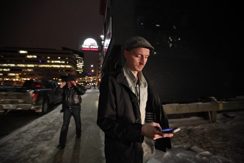 RUTH BONNEVILLE / WINNIPEG FREE PRESS

Winnipeg Free Press reporter Ryan Thorpe books a cab with a online app outside the Pint on Garry street Friday. 
For story on what the local cab service is like.  

See Ryan Thorpe story.   
(ride hailing, ride sharing, uber)
Dec 15, 2017
