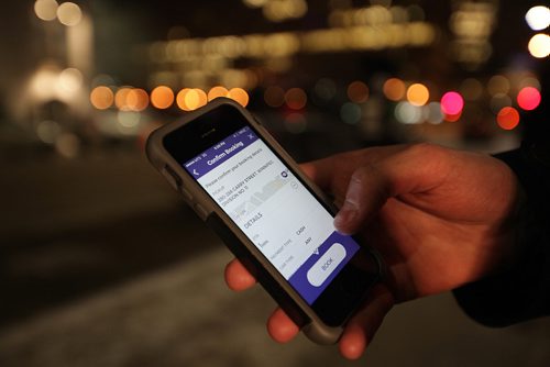 RUTH BONNEVILLE / WINNIPEG FREE PRESS

Winnipeg Free Press reporter Ryan Thorpe books a cab with a online app outside the Pint on Garry street Friday. 
For story on what the local cab service is like.  

See Ryan Thorpe story.   
(ride hailing, ride sharing, uber)
Dec 15, 2017
