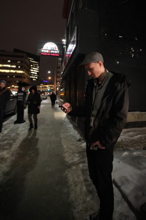 RUTH BONNEVILLE / WINNIPEG FREE PRESS

Winnipeg Free Press reporter Ryan Thorpe books a cab with a online app outside the Pint on Garry street Friday. 
For story on what the local cab service is like.  

See Ryan Thorpe story.   
(ride hailing, ride sharing, uber)
Dec 15, 2017
