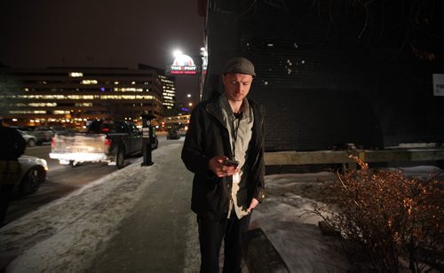 RUTH BONNEVILLE / WINNIPEG FREE PRESS

Winnipeg Free Press reporter Ryan Thorpe books a cab with a online app outside the Pint on Garry street Friday. 
For story on what the local cab service is like.  

See Ryan Thorpe story.   
(ride hailing, ride sharing, uber)
Dec 15, 2017
