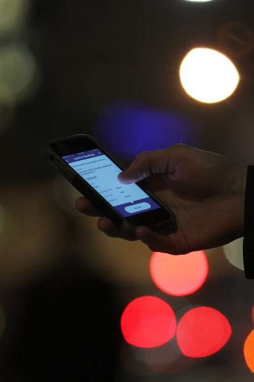 RUTH BONNEVILLE / WINNIPEG FREE PRESS

Winnipeg Free Press reporter Ryan Thorpe books a cab with a online app outside the Pint on Garry street Friday. 
For story on what the local cab service is like.  

See Ryan Thorpe story.   
(ride hailing, ride sharing, uber)
Dec 15, 2017
