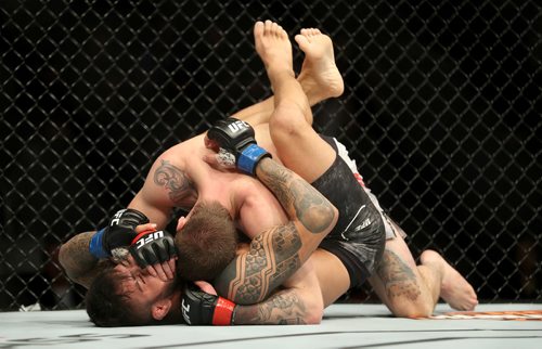 TREVOR HAGAN / WINNIPEG FREE PRESS
Jordan Mein, top, defeats Erick Silva during their welterweight bout to start UFC on Fox 26 at Bell MTS Place, Saturday, December 16, 2017.