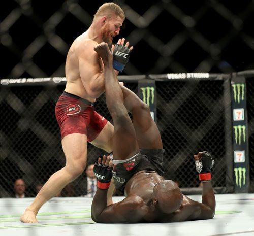 TREVOR HAGAN / WINNIPEG FREE PRESS 
Jan Blachowicz, top, dodges a kick by Jared Cannonier during their light heavyweight bout at UFC on Fox 26 at Bell MTS Place, Saturday, December 16, 2017. Blachoqicz would win.