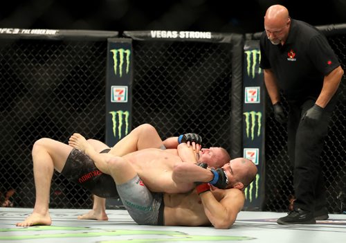 TREVOR HAGAN / WINNIPEG FREE PRESS
Glover Teixeira, bottom, tries to choke Misha Cirkunov during their light heavyweight bout at UFC on Fox 26 at Bell MTS Place, Saturday, December 16, 2017. Teixeira would win by TKO.