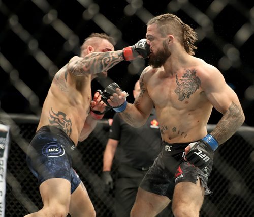 TREVOR HAGAN / WINNIPEG FREE PRESS
Santiago Ponzinibbio, left, defeats Mike Perry during their welterweight bout at UFC on Fox 26 at Bell MTS Place, Saturday, December 16, 2017.