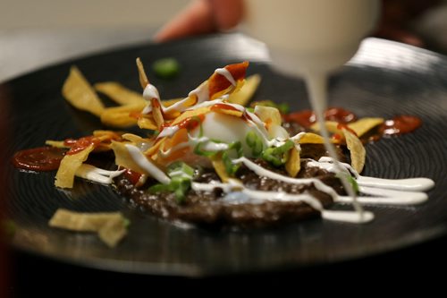 TREVOR HAGAN / WINNIPEG FREE PRESS
Chef Ben Kramer prepares chilaques, the main course during the Sunday Brunch Collective at the Kitchen Sync, Sunday, December 17, 2017.