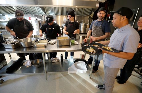 TREVOR HAGAN / WINNIPEG FREE PRESS
Chef Ben Kramer, second from right, and his team preparing chilaques during the Sunday Brunch Collective at the Kitchen Sync, Sunday, December 17, 2017.
