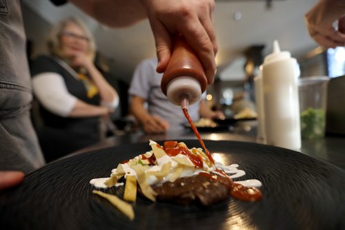 TREVOR HAGAN / WINNIPEG FREE PRESS
Chef Ben Kramer prepares chilaques, the main course during the Sunday Brunch Collective at the Kitchen Sync, Sunday, December 17, 2017.