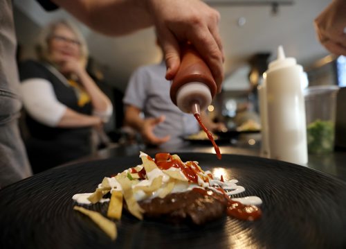 TREVOR HAGAN / WINNIPEG FREE PRESS
Chef Ben Kramer prepares chilaques, the main course during the Sunday Brunch Collective at the Kitchen Sync, Sunday, December 17, 2017.