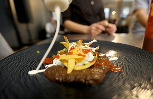 TREVOR HAGAN / WINNIPEG FREE PRESS
Chef Ben Kramer prepares chilaques, the main course during the Sunday Brunch Collective at the Kitchen Sync, Sunday, December 17, 2017.