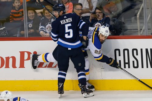 JOHN WOODS / WINNIPEG FREE PRESS
Winnipeg Jets' Dmitry Kulikov (5) and St. Louis Blues' Chris Thorburn (22) look for the loose puck during first period NHL action in Winnipeg on Sunday, December 17, 2017.