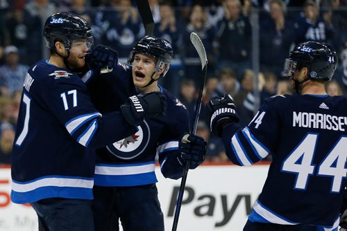 JOHN WOODS / WINNIPEG FREE PRESS
Winnipeg Jets' Adam Lowry (17), Andrew Copp (9) and Josh Morrissey (44) celebrate Lowry's goal against the St. Louis Blues during second period NHL action in Winnipeg on Sunday, December 17, 2017.