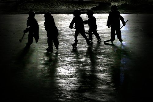 JOHN WOODS / WINNIPEG FREE PRESS
Children chase a puck around the Duck Pond rink at Assiniboine Park Monday, December 18, 2017.