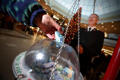 JOHN WOODS / WINNIPEG FREE PRESS
Salvation Army volunteer Roy Dueck stands with a donation kettle in Polo Park Tuesday, December 19, 2017. Charitable donations are down this year.