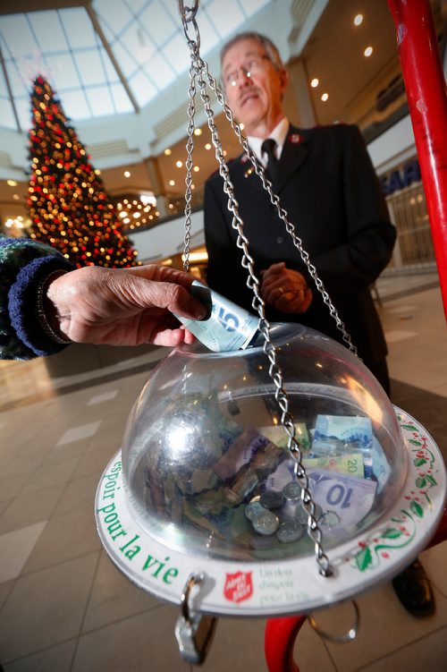 JOHN WOODS / WINNIPEG FREE PRESS
Salvation Army volunteer Roy Dueck stands with a donation kettle in Polo Park Tuesday, December 19, 2017. Charitable donations are down this year.