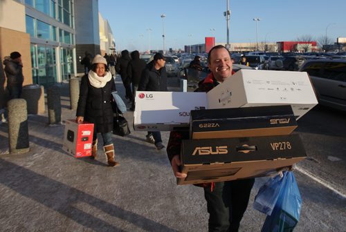 RUTH BONNEVILLE / WINNIPEG FREE PRESS

Kevin Maxzurek walks out of Best Buy at Polo Park loaded down with deals  along with hundreds of other bargain hunters braving the cold for the annual boxing day salesTuesday. 



Dec 26, 2017
