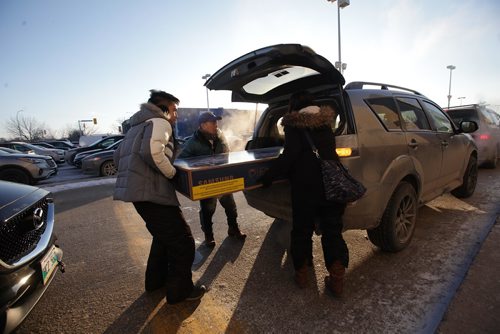 RUTH BONNEVILLE / WINNIPEG FREE PRESS

Gino Msrtasigan gets help from his wife Raquel and dad to load up a big screen TV into his van in the cold outside Best Buy at Polo Park Tuesday.  They were just a few of the hundreds of bargain hunters who braved the cold for the annual boxing day sales.



Dec 26, 2017
