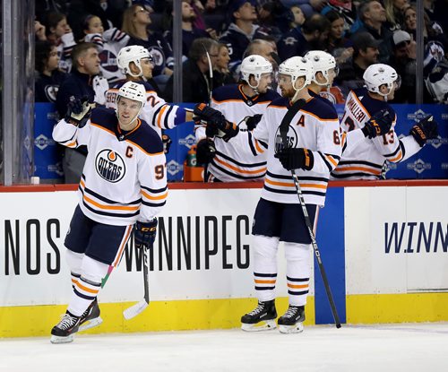 TREVOR HAGAN / WINNIPEG FREE PRESS
Edmonton Oilers' Connor McDavid (97) celebrates with the bench after he assisted on the short handed goal by Leon Draisaitl (29) against the Winnipeg Jets' during first period NHL hockey action, Wednesday, December 27, 2017.