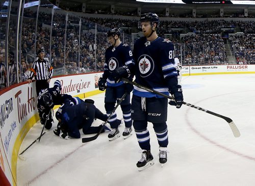 TREVOR HAGAN / WINNIPEG FREE PRESS
Winnipeg Jets' Mark Scheifele (55) lays on the ice after being injured while playing against the Edmonton Oilers' during second period NHL hockey action, Wednesday, December 27, 2017.