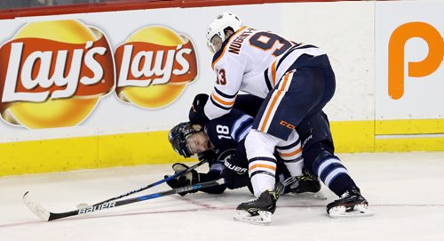 TREVOR HAGAN / WINNIPEG FREE PRESS
Winnipeg Jets' Bryan Little (18) is pushed to the ice by Edmonton Oilers' Ryan Nugent-Hopkins (93) during third period NHL hockey action, Wednesday, December 27, 2017.