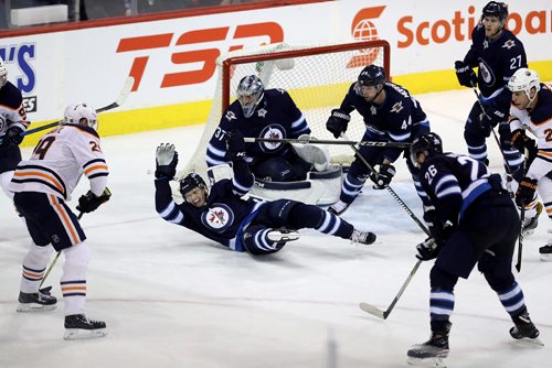 TREVOR HAGAN / WINNIPEG FREE PRESS
Winnipeg Jets' Jacob Trouba (8) lays down to block a shot in front of goaltender Connor Hellebuyck (37) as Edmonton Oilers' Leon Draisaitl (29) carries the puck during third period NHL hockey action, Wednesday, December 27, 2017.
