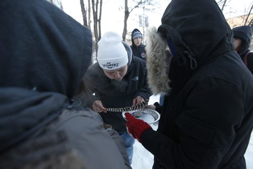 PHIL HOSSACK / WINNIPEG FREE PRESS -  Brittany  Murdoch lights and blows on a smudge to offer her brother Jeremy Thursday afternoon in front of the house where his was found dead of an overdose Christas Eve. See story.  -  December 28, 2017