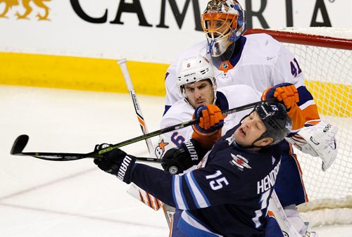 PHIL HOSSACK / Winnipeg Free Press - Winnipeg Jet #15 Matt Hendricks takes a cross check to the chin by New York Islander #6 Ryan Purlock Friday night at Bell MTS Place. Purlock was sent away for cross checking. December 29, 2017