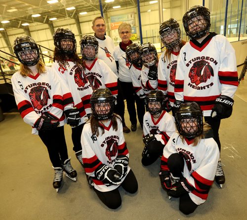 TREVOR HAGAN / WINNIPEG FREE PRESS
George and Marg Bond, grandparents of Keira Bond who died last year after a short battle with cancer, posing with Keira's ringette teammates while fundraising for Keira's Krusade, Saturday, December 30, 2017.