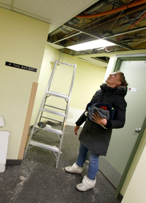 PHIL HOSSACK / Winnipeg Free Press - Tessa Blaikie checks out the source of water damage in the basement at St Augustine Church on River Ave Monday.  See story re: WarmSleep.   - January 1, 2018