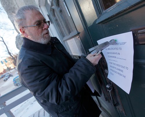 PHIL HOSSACK / Winnipeg Free Press - Bob Gilbert, Minister at St Augustine hammers home a notice saying "Warm Sleep" has moved to Crossways on Furby at Broadway.  - January 1, 2018