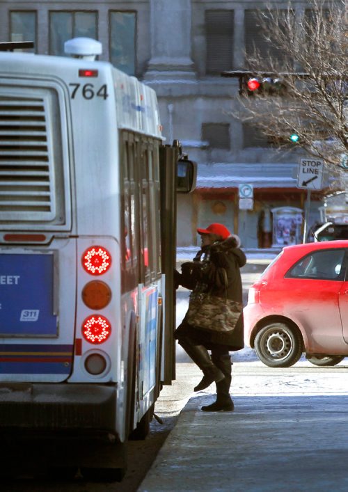 PHIL HOSSACK / Winnipeg Free Press - A transit passenger steps into a waiting bus along Graham Ave Monday morning despite the chill of higher fares. - January 1, 2018