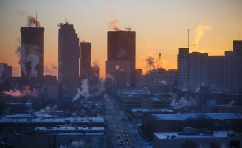 MIKE DEAL / WINNIPEG FREE PRESS
The sun rises over downtown Winnipeg as seen from the new Manitoba Clinic building.
180104 - Thursday, January 04, 2018.