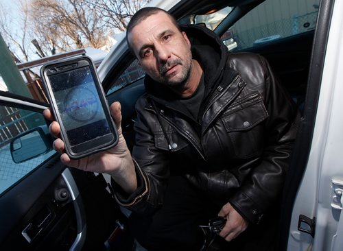 PHIL HOSSACK / Winnipeg Free Press -  Pete Contois shows off the phone app he uses to have people book his ride service. See Maggie MacIntosh story. -   January 4, 2018