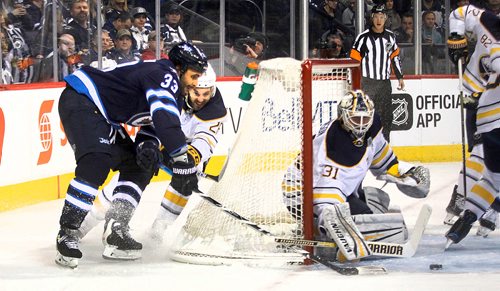 PHIL HOSSACK / Winnipeg Free Press -   Winnipeg Jet #33 Dustin Byfuglien wraps one around from behind at Buffalo Sabre's Chad Johnson despite the efforts of #28 Zemgus Girgensons Thursday at Bell MTS Place as the Sabres took on the Winnipeg Jets. January 5, 2018