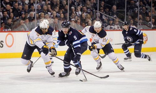 PHIL HOSSACK / Winnipeg Free Press -   Winnipeg Jet #9 Andrew Copp works past Buffalo Sabre #9 Evander Kane in the second period Thursday at Bell MTS Place as the Sabres took on the Winnipeg Jets. Sabres #19 Jake McKabe follows up. - January 5, 2018