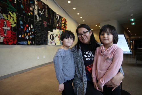 RUTH BONNEVILLE / WINNIPEG FREE PRESS

BLANKET TOUR: The National Story Blanket Tour,  stories from youth leaders from across Canada of reconciliation, community and solidarity. was on display at the CMHR on Saturday. (A second opportunity to see it and will be on Jan 17th).  
Amber Beaulieu and her six-year-old twin daughters Sloane (left) and Brinley (pink) have their picture taken after looking at the Blanket at CMHR Saturday.  Beaulieu works for Canadian Roots Exchange who helped to bring the blanket to be viewed at CMHR.  
Standup photo

Jan 06, 2018
