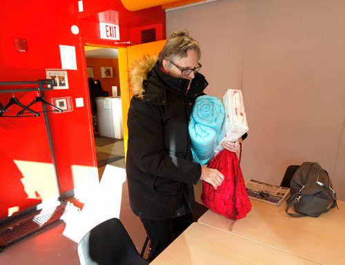 PHIL HOSSACK / Winnipeg Free Press -  Karin Gordon scoops up supplies including a toiletry kit, blankets and sheets at Welcome Place for 36 yr old Kangni Kouevi from Togo who walked across the Emerson border crossing from North Dakota last night. He has severe frostbite to both his hands. Carol Sanders story. - January 8, 2018