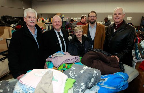 BORIS MINKEVICH / WINNIPEG FREE PRESS
Today Siloam Mission received a donation of clothing from the upcoming television series Burden of Truth, as well as a cash donation, from the series Winnipeg filming location, Stantec. From left, Jim Bell, Chief Executive Officer, Siloam Mission, Kenny Boyce, Manager, Film and Special Events, City of Winnipeg, Lesley Oswald, Production Manager, Burden of Truth, Kyle Irving, Co-Executive Producer, Burden of Truth, and Eric Wiens, Vice President and Manitoba Regional Leader, Stantec. Photo taken in the sorting area of Siloam Mission. Jessica Botelho-Urbanski story. January 9, 2018