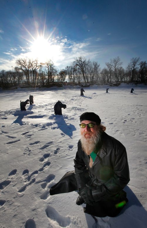 PHIL HOSSACK / Winnipeg Free Press -  Jordan Van Sewel poses on the Red River with a set of horse head silouettes he's installed on the ice. See Doug Spiers story.  - January 9, 2018