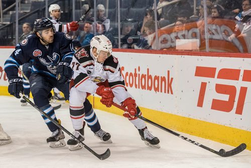 DAVID LIPNOWSKI / WINNIPEG FREE PRESS

Manitoba Moose Jake Kulevich (#14) jostles for the puck with Grand Rapids Griffins  Evgeny Svechnikov (#77) during first period action at Bell MTS Place Wednesday January 10, 2018.
