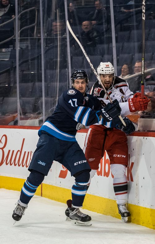 DAVID LIPNOWSKI / WINNIPEG FREE PRESS

Manitoba Moose Jimmy Lodge (#17) checks Grand Rapids Griffins Brian Lashoff (#18) into the boards during second period action at Bell MTS Place Wednesday January 10, 2018.
