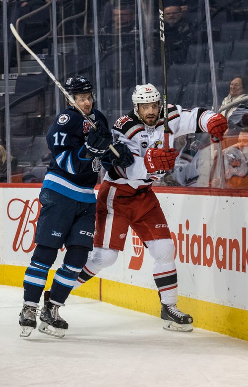 DAVID LIPNOWSKI / WINNIPEG FREE PRESS

Manitoba Moose Jimmy Lodge (#17) checks Grand Rapids Griffins Brian Lashoff (#18) into the boards during second period action at Bell MTS Place Wednesday January 10, 2018.
