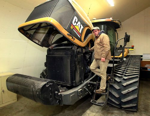 BORIS MINKEVICH / WINNIPEG FREE PRESS
Mike Bast is a grain farmer pleased by the elimination of the Canadian Wheat Board. Here he is with one of his big tractors in a storage shed. Story about The Canadian Wheat Board, five years later: how farming has fared. Kelly Taylor story. January 11, 2018