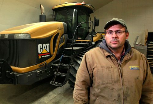BORIS MINKEVICH / WINNIPEG FREE PRESS
Mike Bast is a grain farmer pleased by the elimination of the Canadian Wheat Board. Here is a portrait of him with one of his big tractors in a storage shed. Story about The Canadian Wheat Board, five years later: how farming has fared. Kelly Taylor story. January 11, 2018