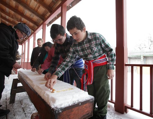 RUTH BONNEVILLE / WINNIPEG FREE PRESS

Marc-André  Normandeu (11yrs),twists some hot maple syrup on snow making a taffy pop with his family at the launch of the 49th annual Festival du Voyageur at a news conference at Fort Gibraltar Tuesday.  
 
Sse Alex Paul story.  
Jan 16, 2018
