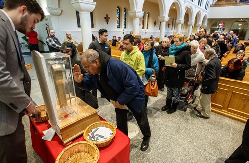 MIKE DEAL / WINNIPEG FREE PRESS
Parishioners take part in the public venerations of the relic of St. Francis Xavier after mass at St. Mary's Cathedral in Winnipeg, MB.
The severed arm of St. Francis Xavier, a Catholic missionary who died more than 400 years ago, is on a tour of Canada and made a stop in Winnipeg at St. Marys Cathedral located at 353 St. Mary Ave.
The arm and hand of the saint -- which is said to have blessed and baptized thousands -- has begun a one-month, tour of Canada that will go until February 2.
180116 - Tuesday, January 16, 2018.